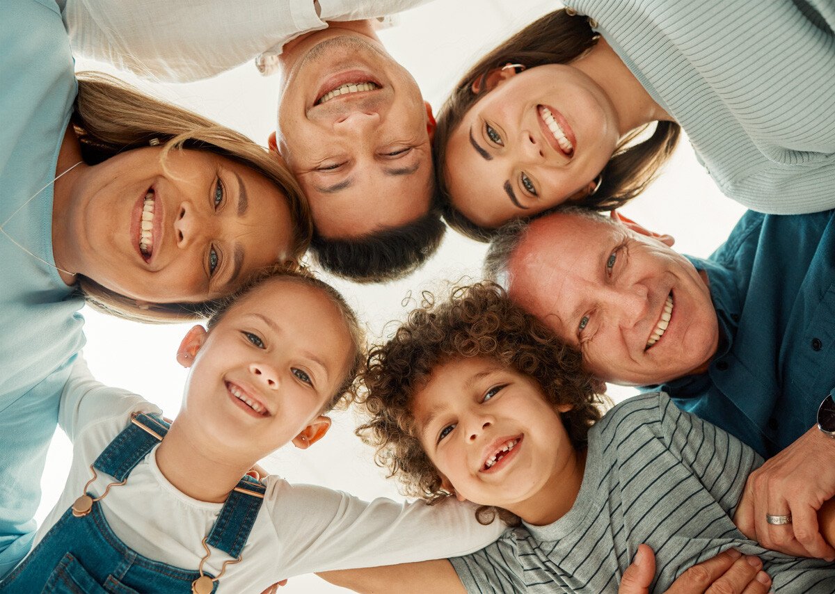 Smiling family in a group huddle hug