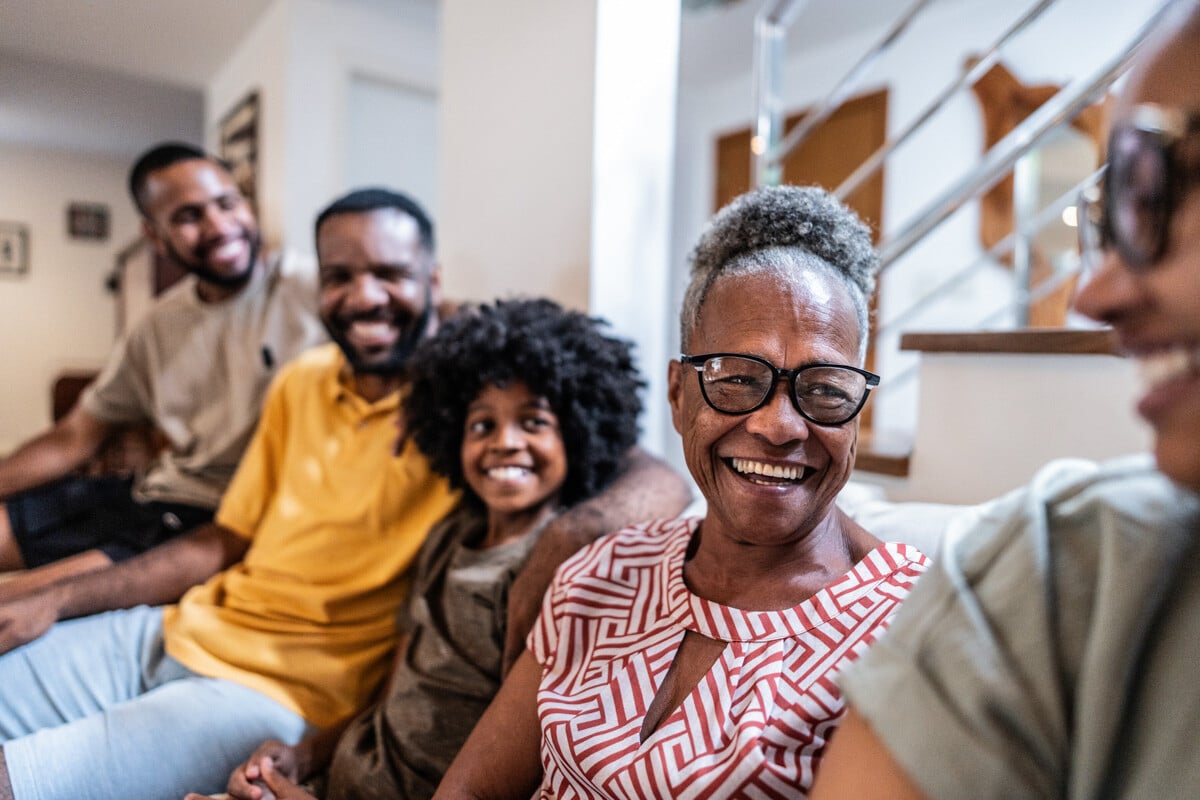 Grandmother smiling while sitting with family