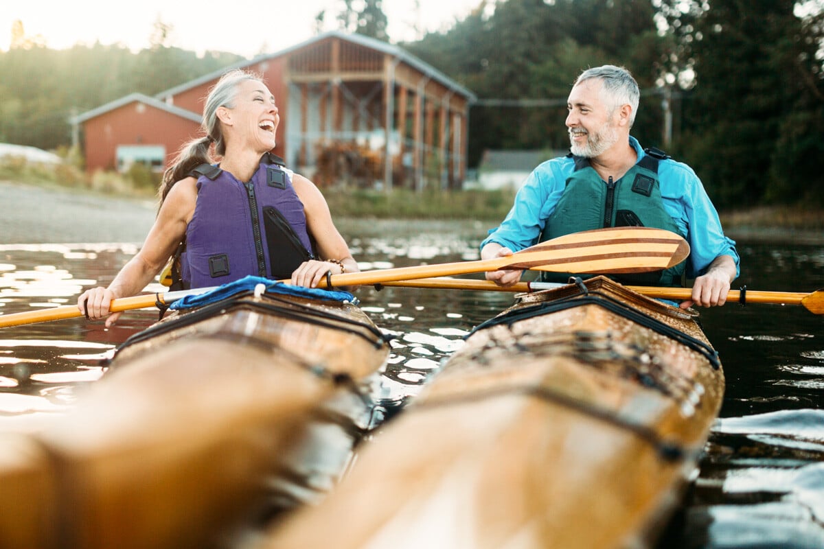 Happy couple kayaking on lake