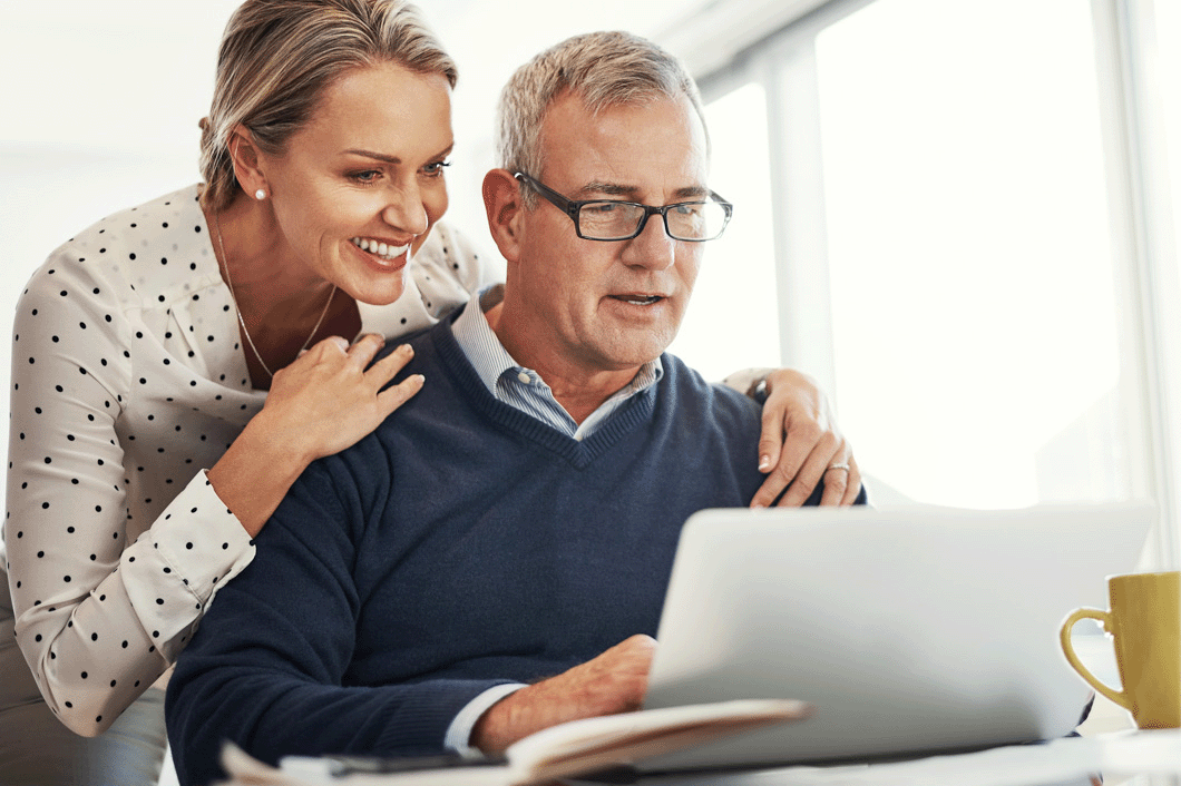 Older mature couple looking at computer screen