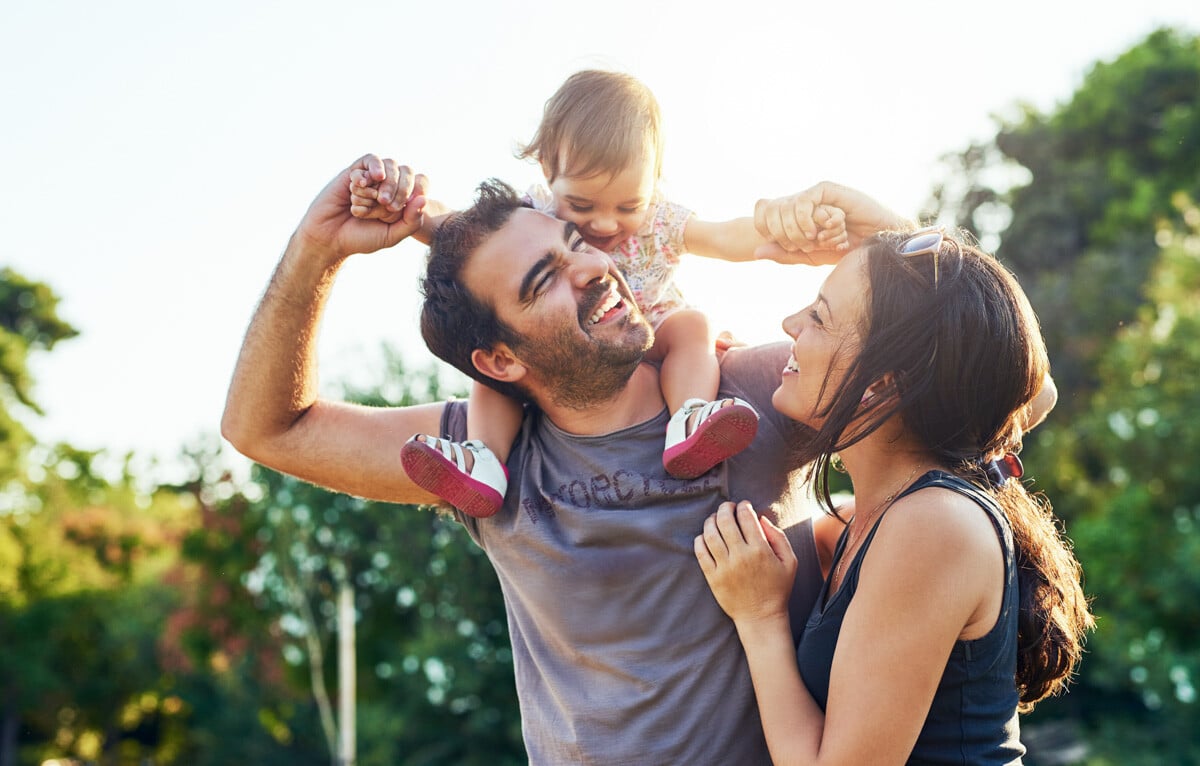 Young couple with child on dad's shoulders